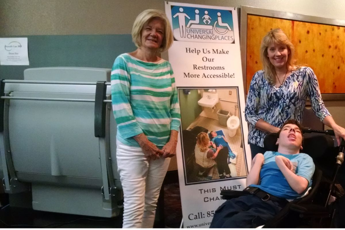 Sabrina Kimball, her son Greyson Channing, and Deretha Heller promoting Universal Changing Places at the 2017 ADA Symposium in Chicago, Illinois, sponsored by MaxAbility and Pressalit. Copy